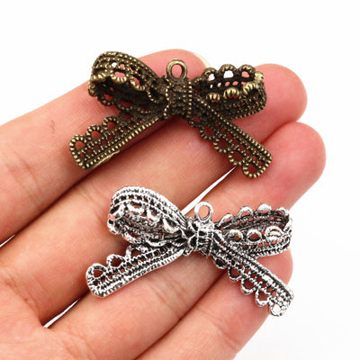 Lace Bow Pendants arranged in the pictured color and finish options