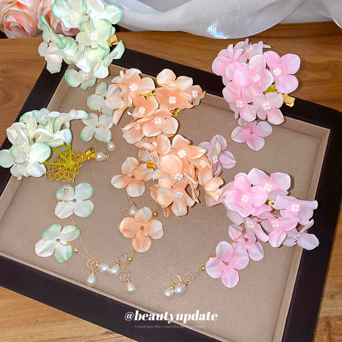 Mint green peach and pink fabric flower clips with pearl drops in tray