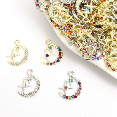 Assorted moon star charms arranged on a white background