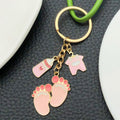 Eight Pink Baby Outfit and Footprint Metal Keychain Designs view 2
