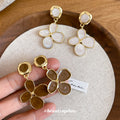 White Four Petal Drop Earrings with Gold Tone Outlines view 2