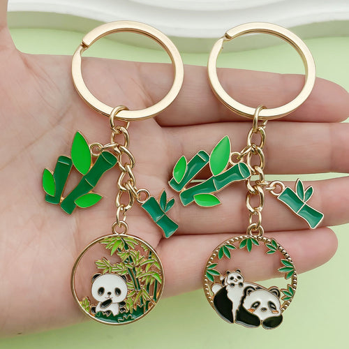 Image 1 showing a person holding two pandas in their hands.
