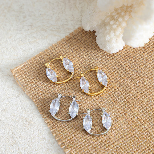Gold and steel marquise glass open hoops on burlap with coral accent