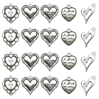 Antique silver heart beads arranged on a light background