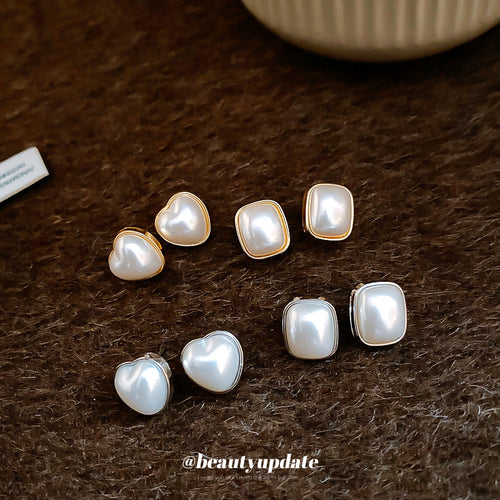 Product view of square pearl-look stud earrings with gold-tone frames