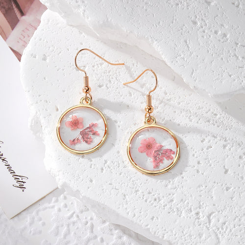 Soft pink pressed flower round resin earrings on gold fishhooks