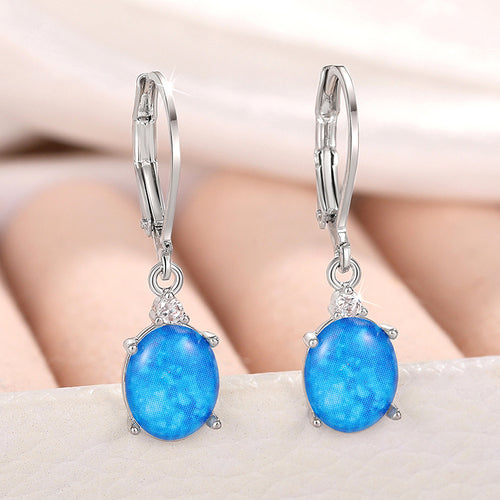 Silver dark blue oval stone leverback earrings pair close front view