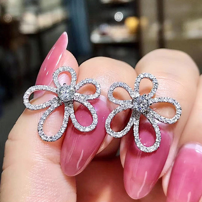 Silver Tone Four Petal Floral Stud Earrings with Clear Stones