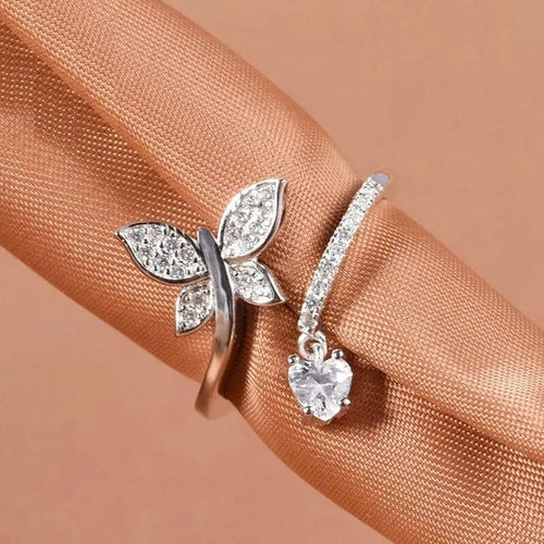 Product view showing an open silver-tone band ending in a crystal butterfly and round stone