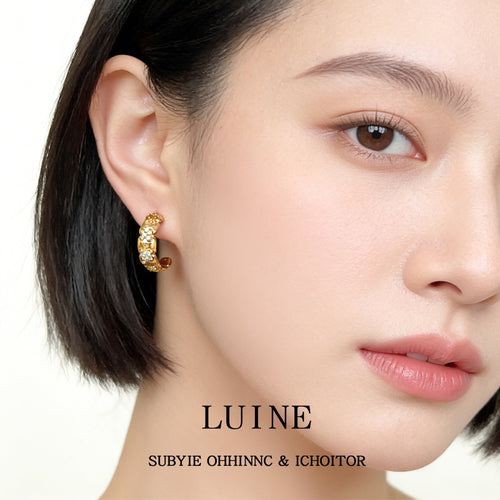 Gold-tone multicolor-stone chunky huggie hoops shown worn on an ear.