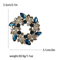 Colorful Crystal Wreath Brooch With Polished Metal And Sculpted Decorative Details view 6