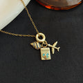 Passport Airplane and Shell Travel Charm Necklace in Gold Tone view 2