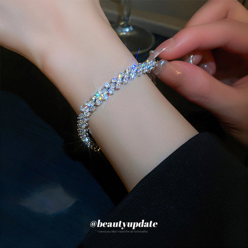 silver-tone tennis bracelet with repeating clear crystal flower links shown in the first close product view