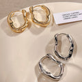 Irregular Sculpted Metal Hoop Earrings in Gold and Silver view 1