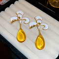 White Enamel Flower Stud Earrings With Yellow Drops view 6