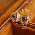 Gold Tone Blue Oval Crystal Stud Earrings with Clear Halo view 4