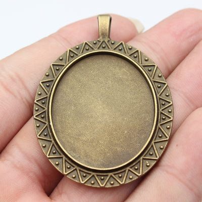 Triangle Border Oval Pendant Setting 30x40mm Two Finishes shown in hand