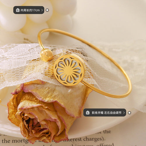 Gold daisy open cuff on lace with inner circumference size label
