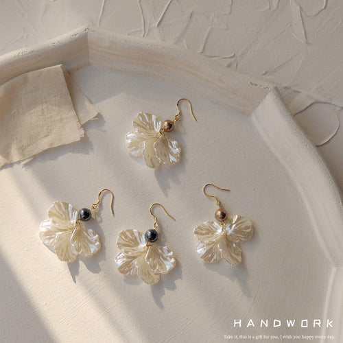 Four cream shell leaf earrings showing dark and brown pearl beads