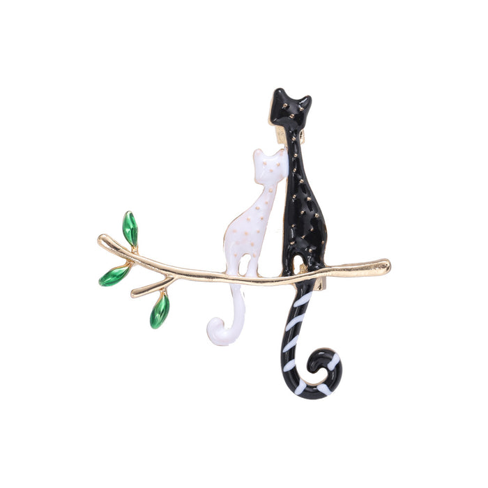 Black and White Cats on Branch Brooch with Green Leaves