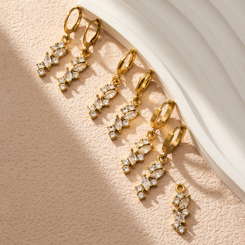 On-ear view of crystal leaf cluster hoop earrings in main image 2.