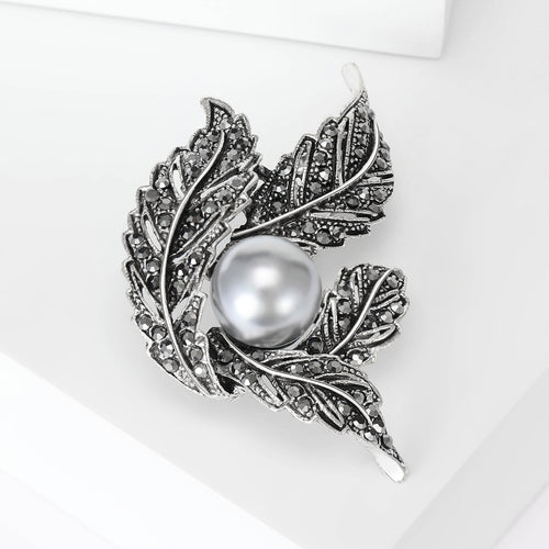 Angled view showing the leaf cluster brooch surface