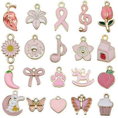Pink bow and butterfly charms arranged on a light background