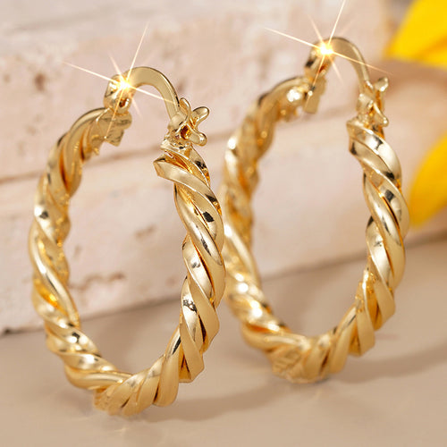 Alternate close view of the gold tone earrings