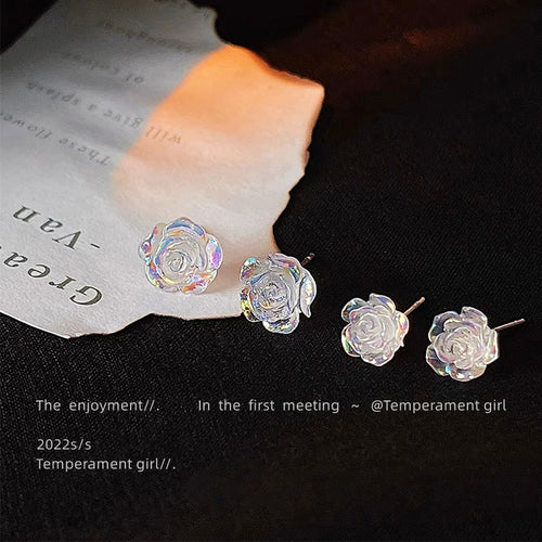 Large and small clear iridescent rose studs on black cloth