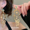 Gold Tone Sun Moon and Snake Dangle Earrings With Polished Metal Details view 1