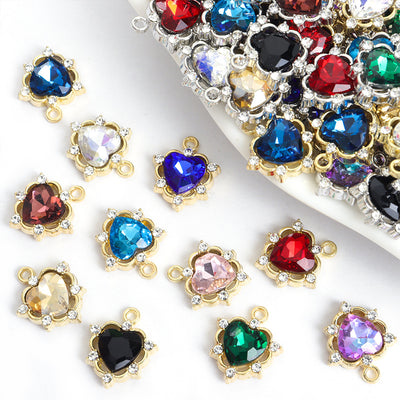 Assorted heart crystal charms arranged beside a mixed pile