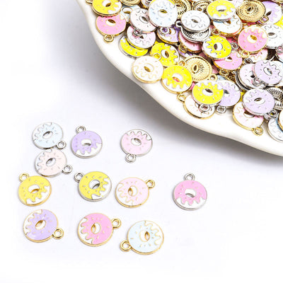 Assorted donut charms arranged on a white surface