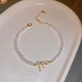 White Pearl Bracelet With Gold Tone Crystal Bow Center view 2