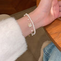 White Pearl Like Double Bracelet Set With Enamel Camellia Charm view 2