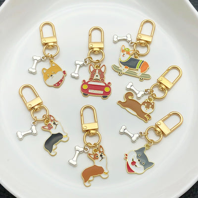 Front display of sixteen sporty dog and bone enamel keychains with visible colors and attached hardware