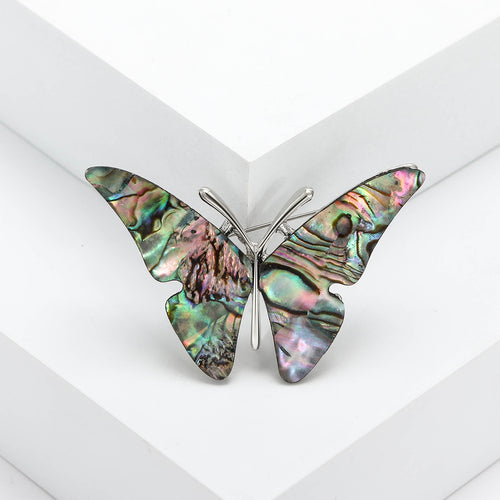 A butterfly with mosaic-like iridescent shell wings shown in a styled display.
