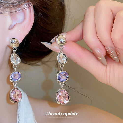 Pink and Purple Crystal Linear Drop Earrings shown in a display view