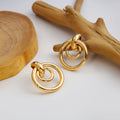 Twelve Gold Tone Sculptural Knot and Hoop Earrings view 2