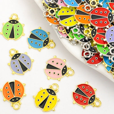 Assorted ladybug charms arranged on a white surface