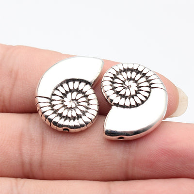 Front view of spiral shell beads in the pictured finish