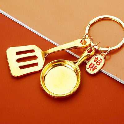 Main image 1 shows a supplied presentation of jeweled gold spatula and frying pan kitchen utensil with visible attached 