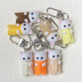 Flocked White Cat Clip Keychains in Nine Outfit Colors view 3