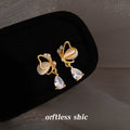 Gold Tone Cream Cat Eye Butterfly Clear Drop Stud Earrings view 1