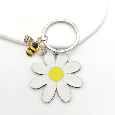 White daisy wood flower and rhinestone bee charm on silver key ring