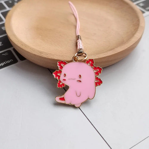 Pink axolotl enamel charm looking sideways with pink phone strap