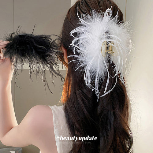mixed assortment of seven black and white feather hair claws shown in the first close product view