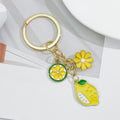 Gold-Tone Enamel Lemon Keychain With Citrus Slice Flower And Butterfly Charms view 6