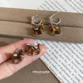 Brown Horse Stud Earrings In Two Metal Tones With Decorative Metal Details view 1