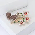 Brown Enamel Squirrel Brooch Beside White Flower Branches view 2