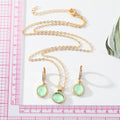 Gold Tone Pale Green Oval Stone Necklace and Huggie Earrings view 2